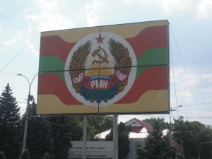 The Transdniestran Coat of Arms, backed by the colours of the Transdniestran flag, red and green.